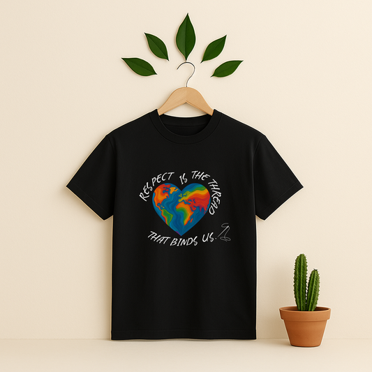 Black t-shirt with a colorful heart design and text on a wooden hanger against a beige background with a cactus plant.