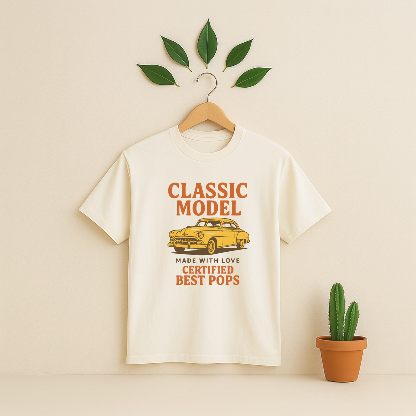 Ivory t-shirt graphic and text on a wooden hanger against a beige background with a cactus plant.
