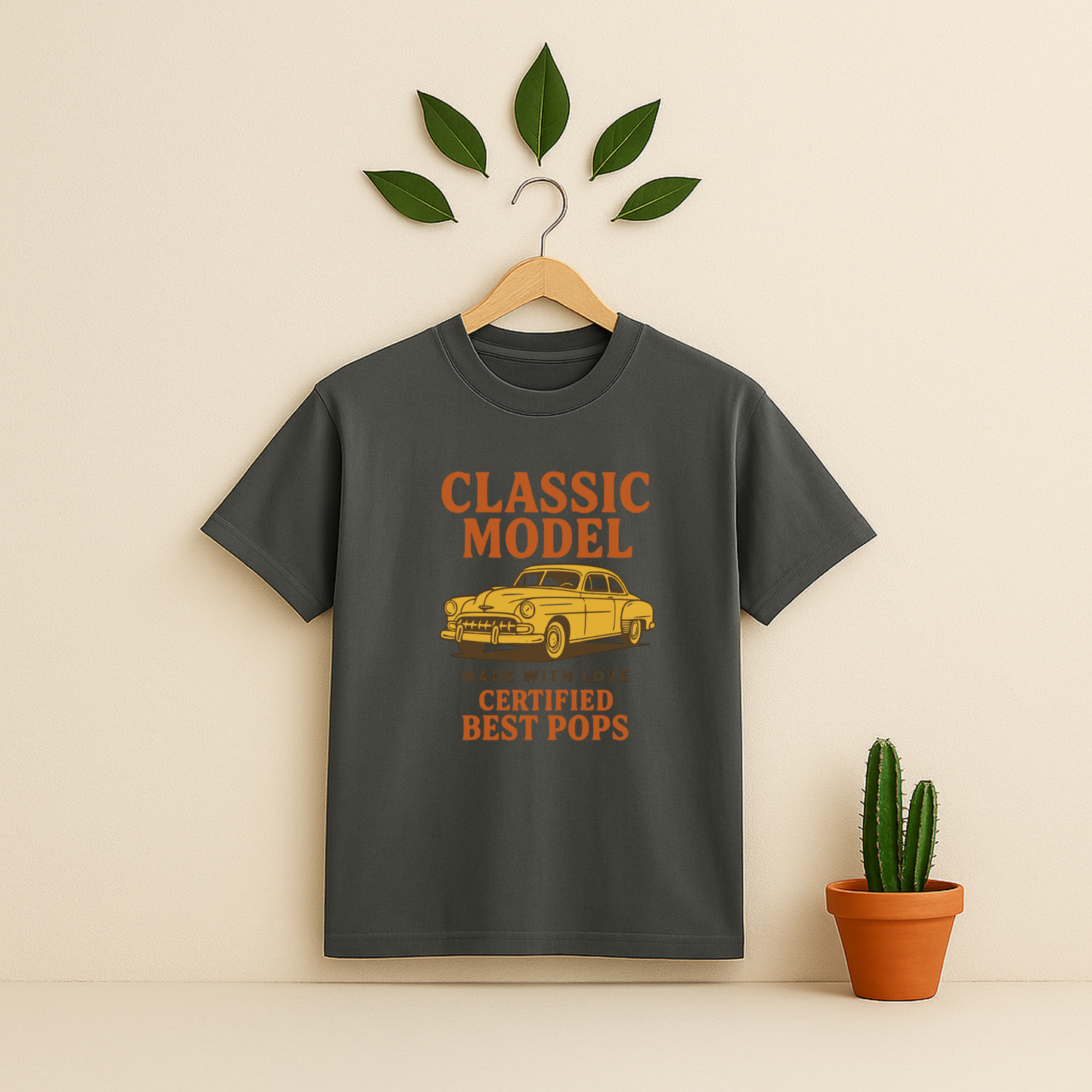 Pepper t-shirt graphic and text on a wooden hanger against a beige background with a cactus plant.