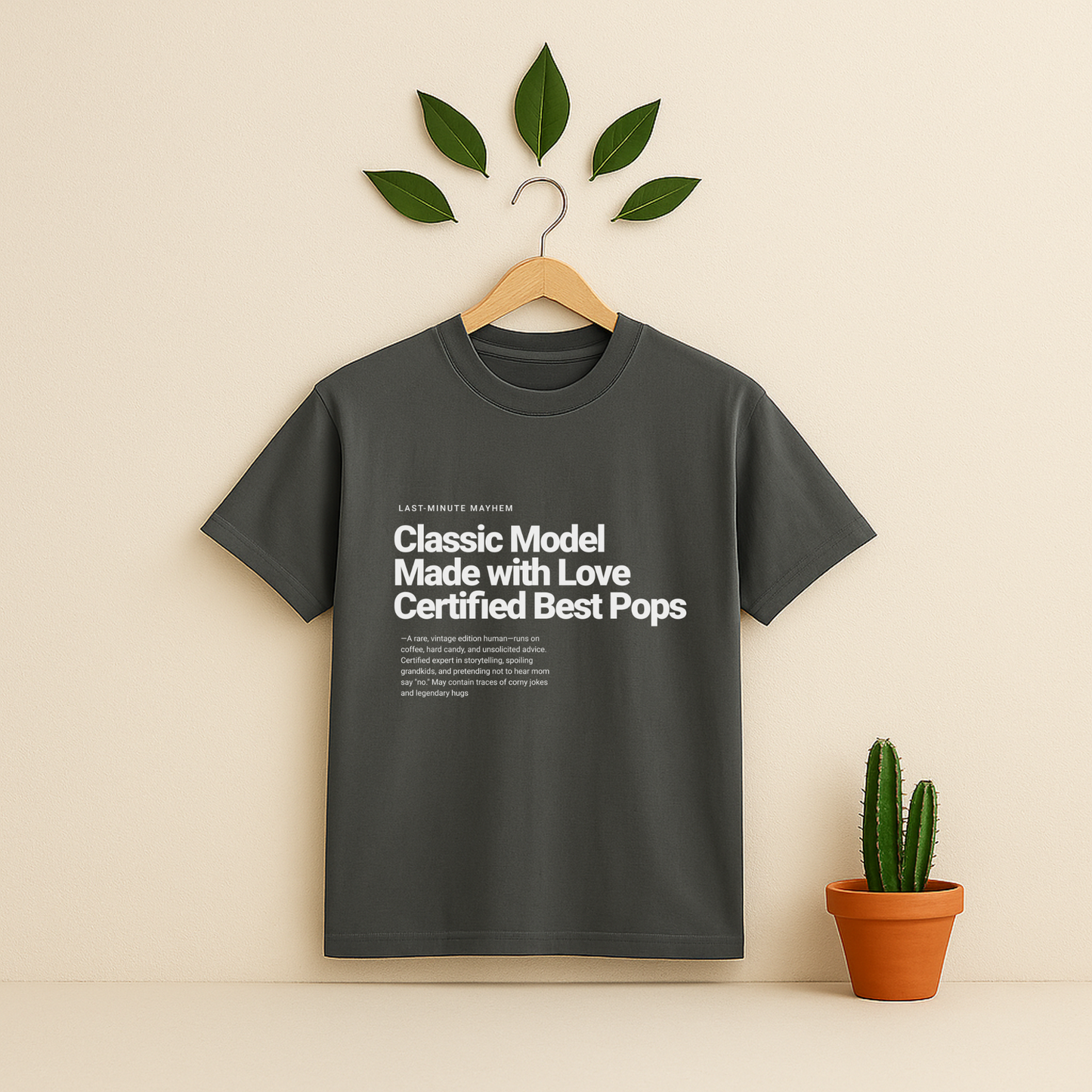 Pepper t-shirt with text on a hanger against a beige background with a potted Cactus plant.