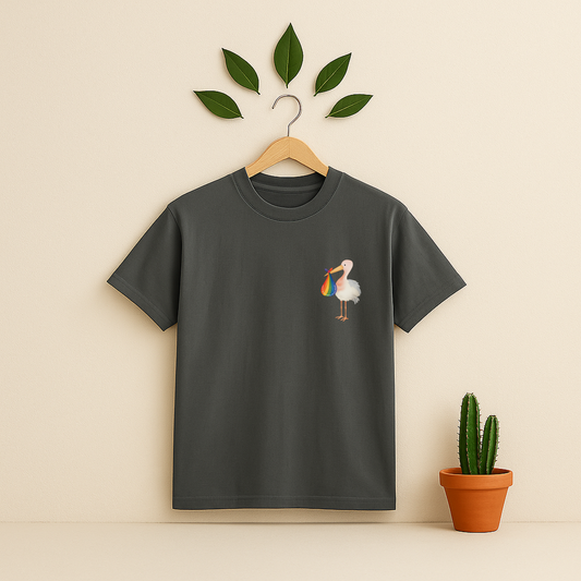 Pepper t-shirt with a colorful bird design on a wooden hanger against a beige background with a cactus plant.