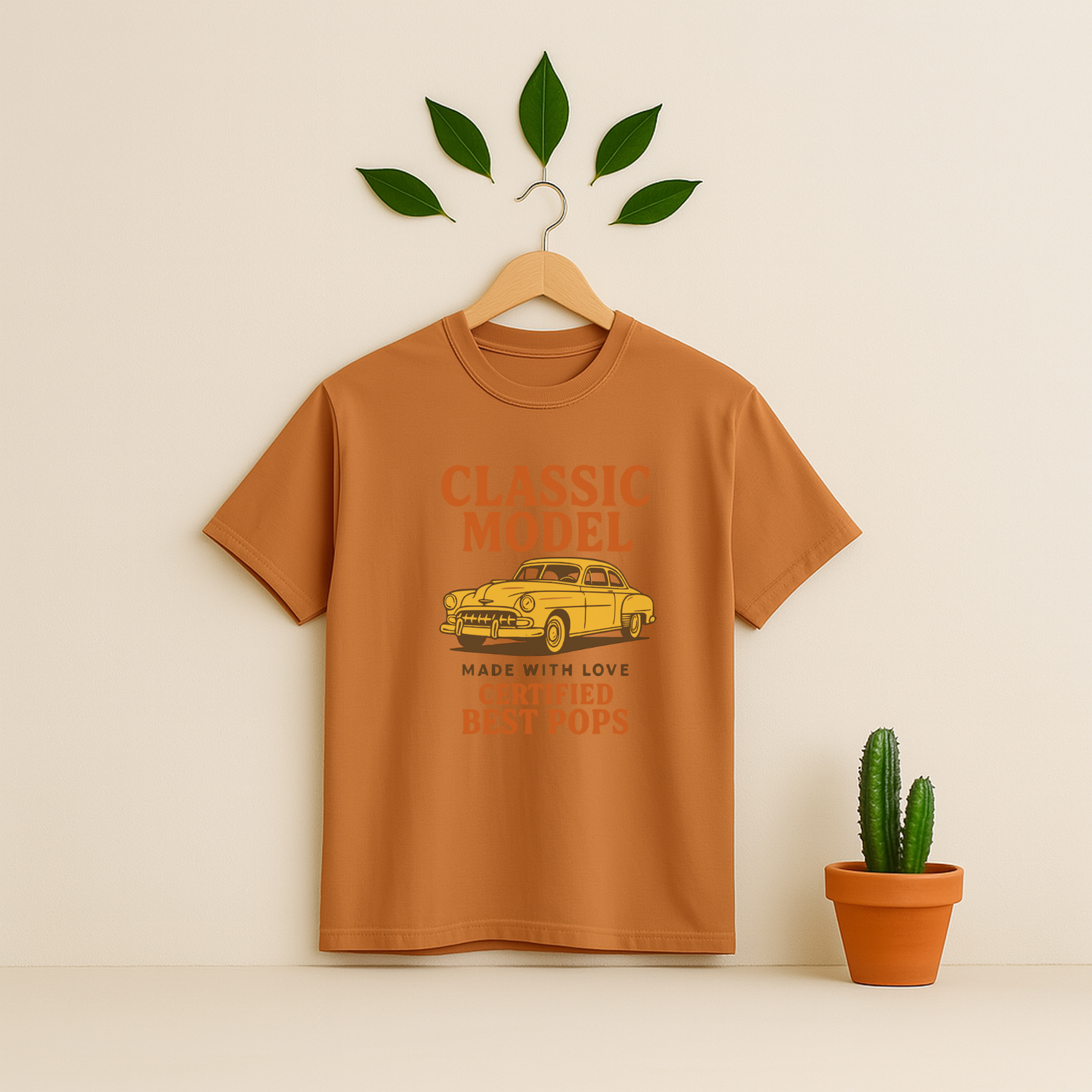 Yam t-shirt graphic and text on a wooden hanger against a beige background with a cactus plant.