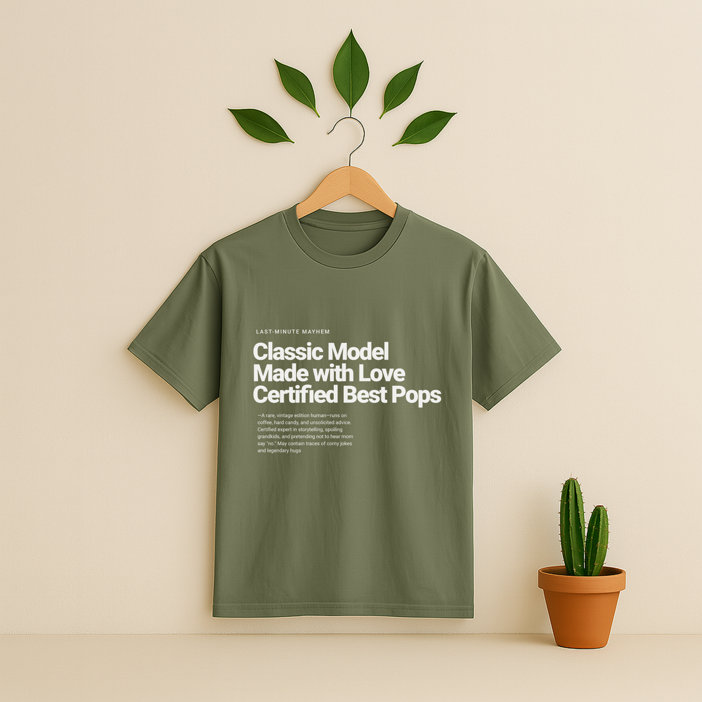 Moss t-shirt with text on a hanger against a beige background with a potted Cactus plant.